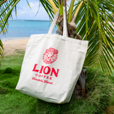 Canvas Tote with Lion logo hanging on a tree branch