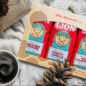 Lion Holiday Flavors Gift Set next to a cup of coffee